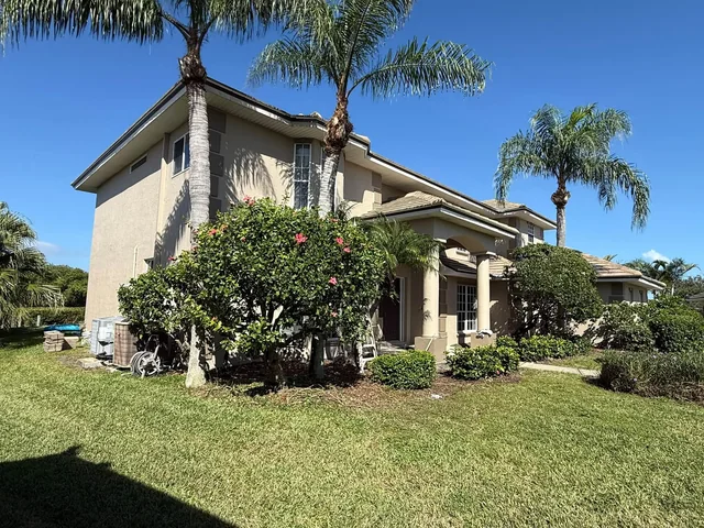 Florida house exterior with light stucco and contrasting architectural trim