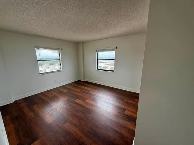 Light-colored interior walls with white trim and wood flooring