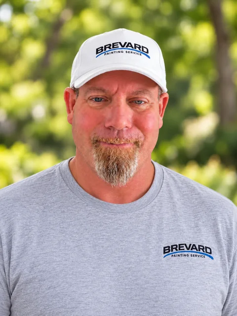 Phil Brown, owner of Brevard Painting Services, wearing his company cap and shirt